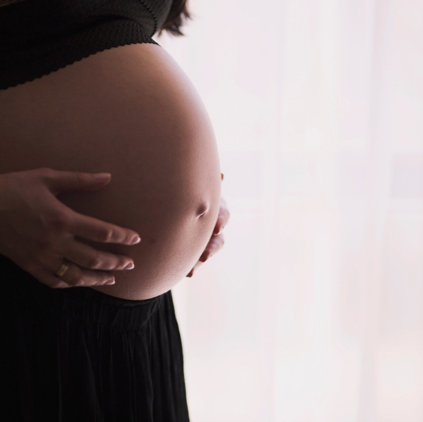 pregnancy women touching stomach