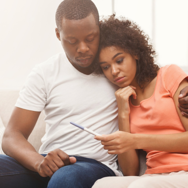 couple looking at pregnancy test result