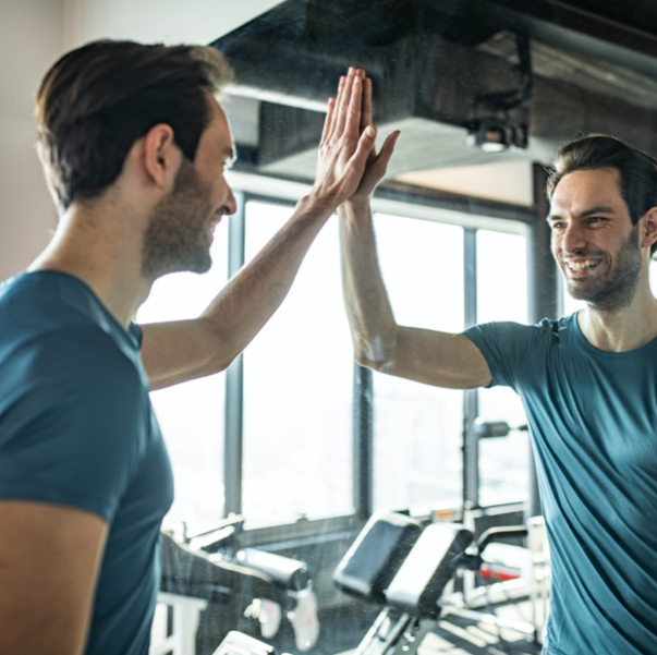 man standing in front of mirror at gym