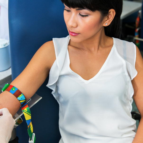 young woman getting blood drawn at lab