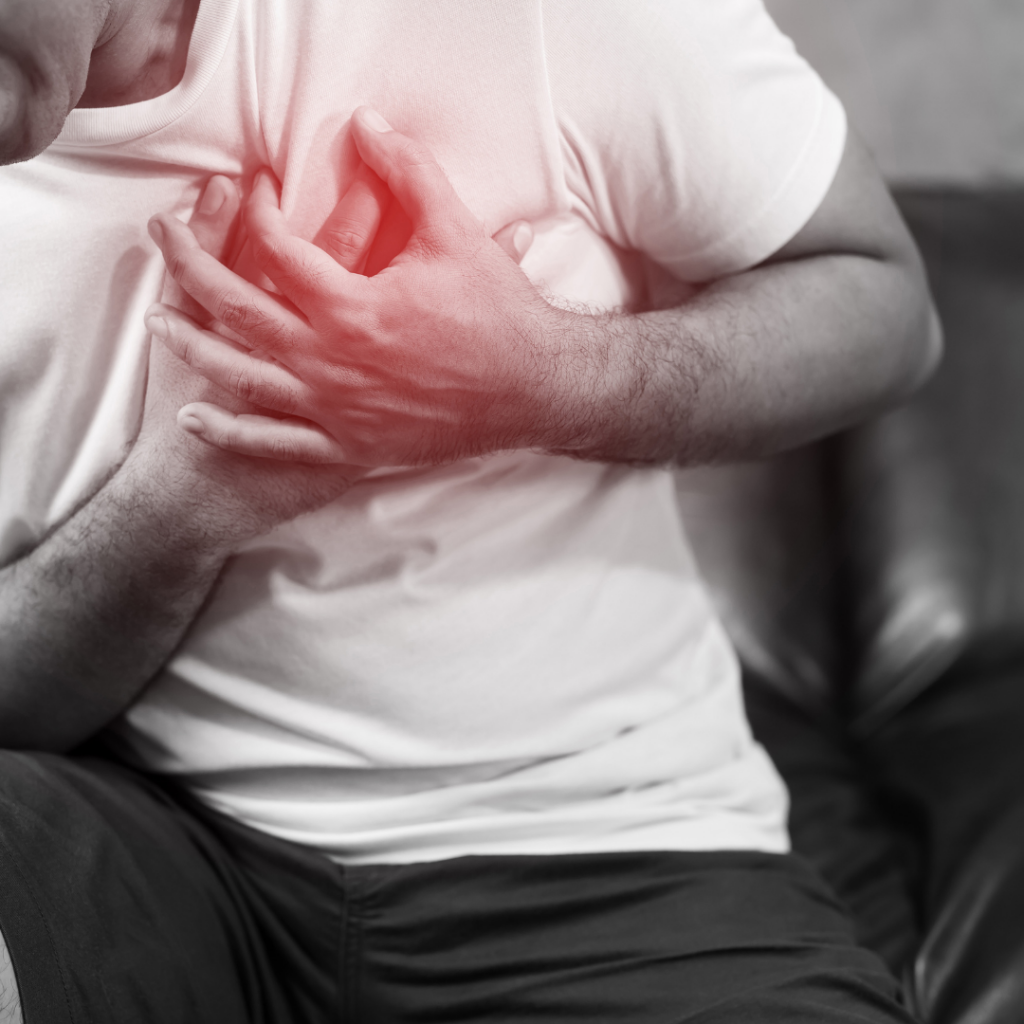 man holding chest in heart pain
