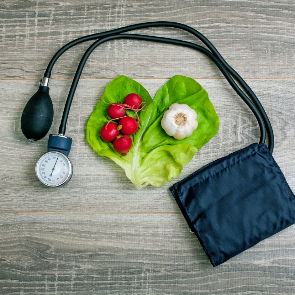 picture of lab stethoscope, blood pressure checker and vegetables on table