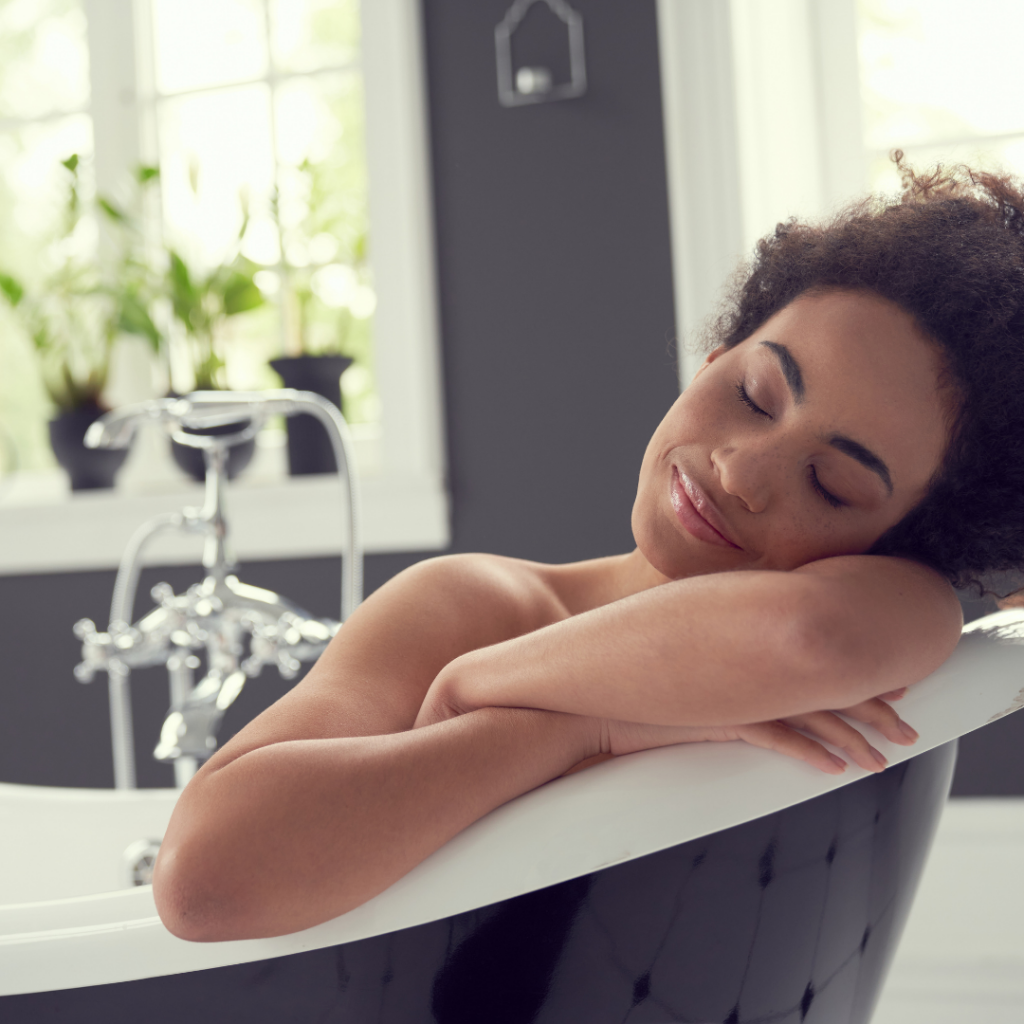 Woman laying in tub trying to relax.