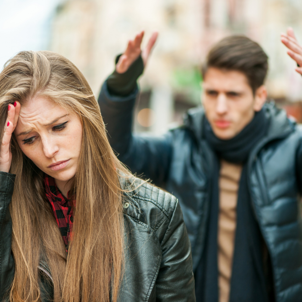 Couple arguing outside in public.