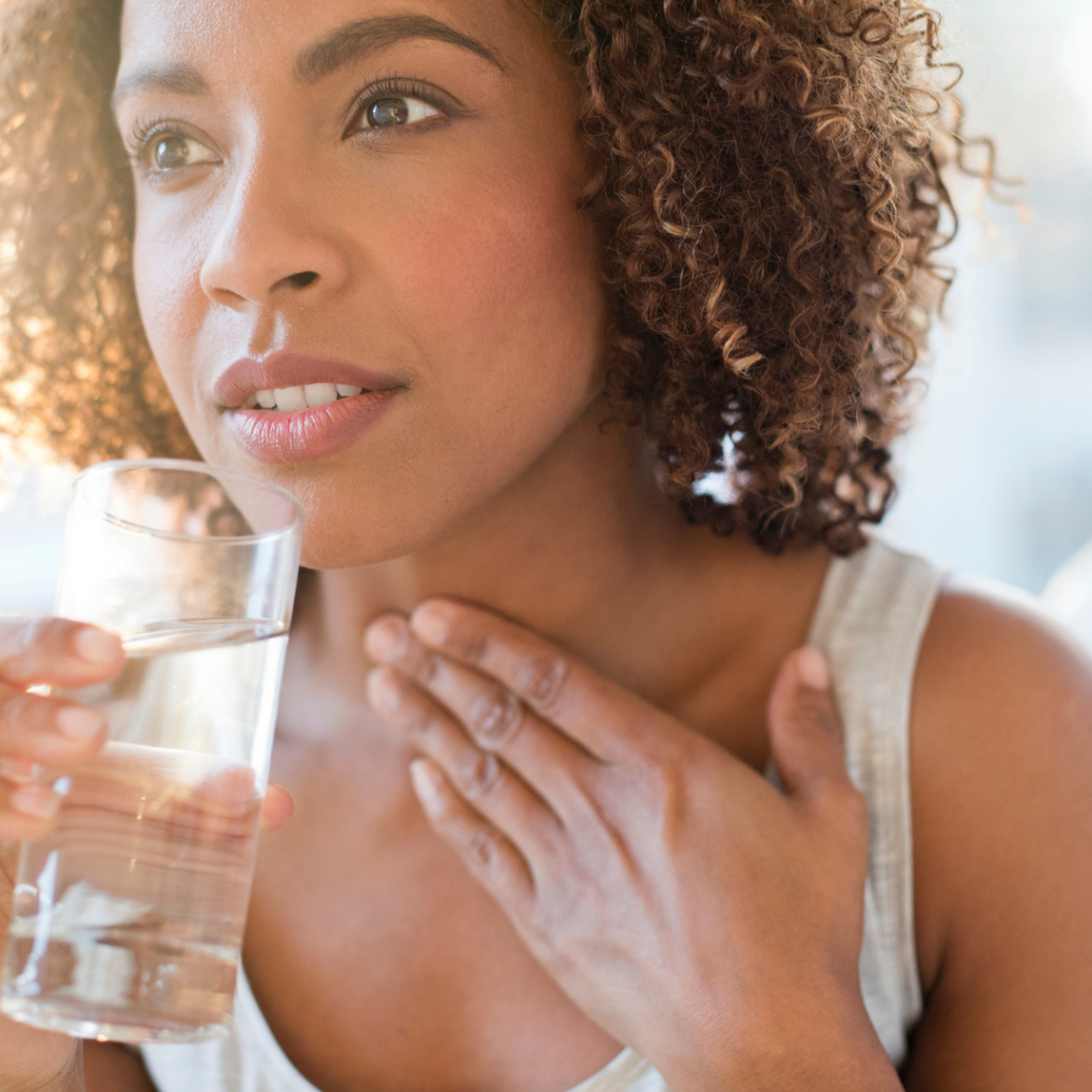 woman drinking salt water to soothe hurt sore throat.