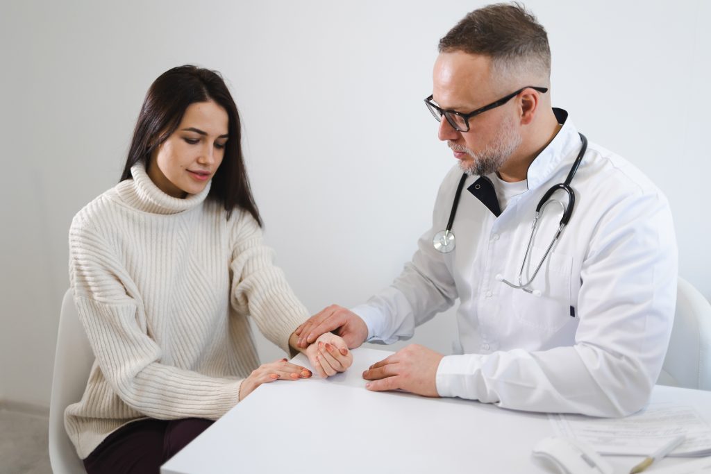 Doctor checking young lady doing annual lab check up 
