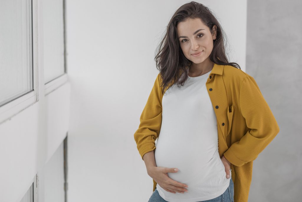 Smiley pregnant woman with copy space