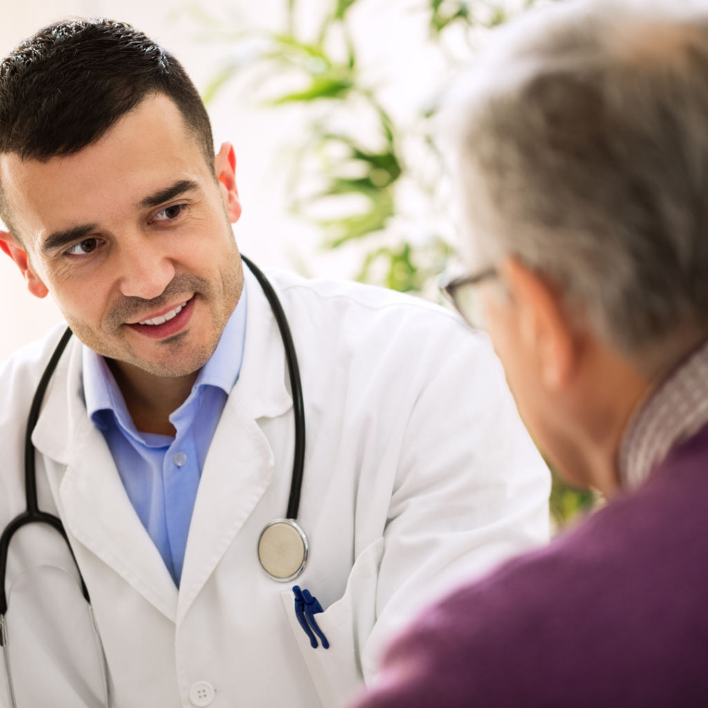 middle aged doctor talking with elderly patient