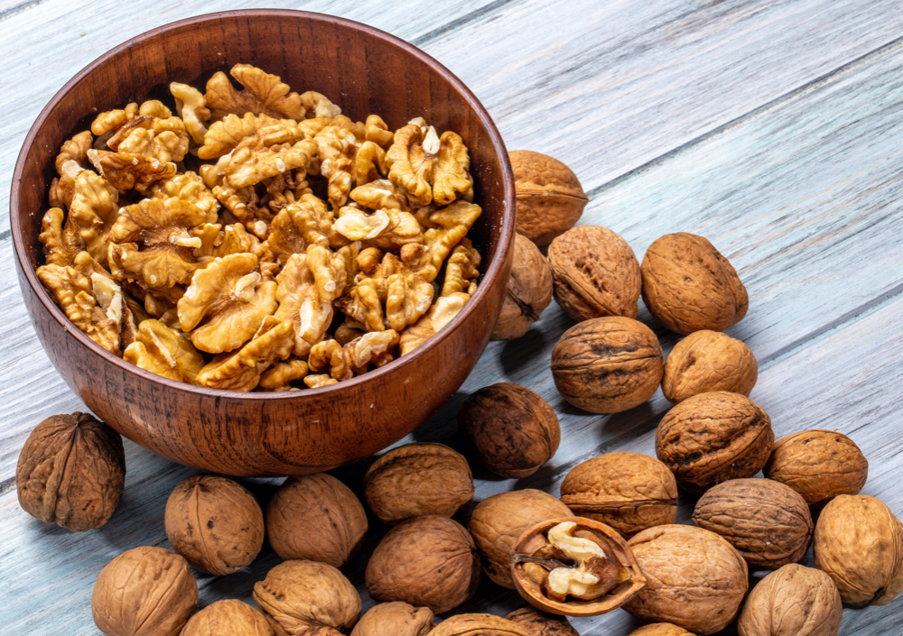 walnuts inside of a brown bowl