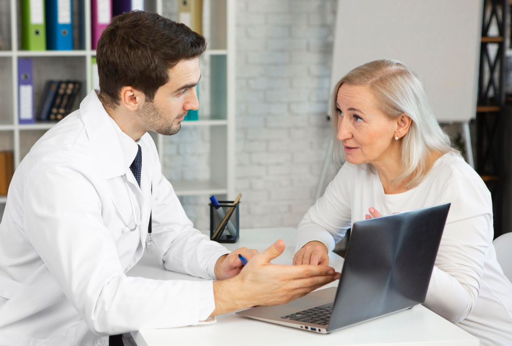 Doctor discussing lupus symptoms and treatment options with a patient during a medical consultation.