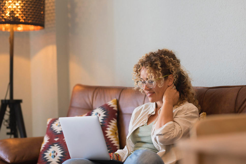 Happy woman at home reviewing her online lab test results on a laptop.