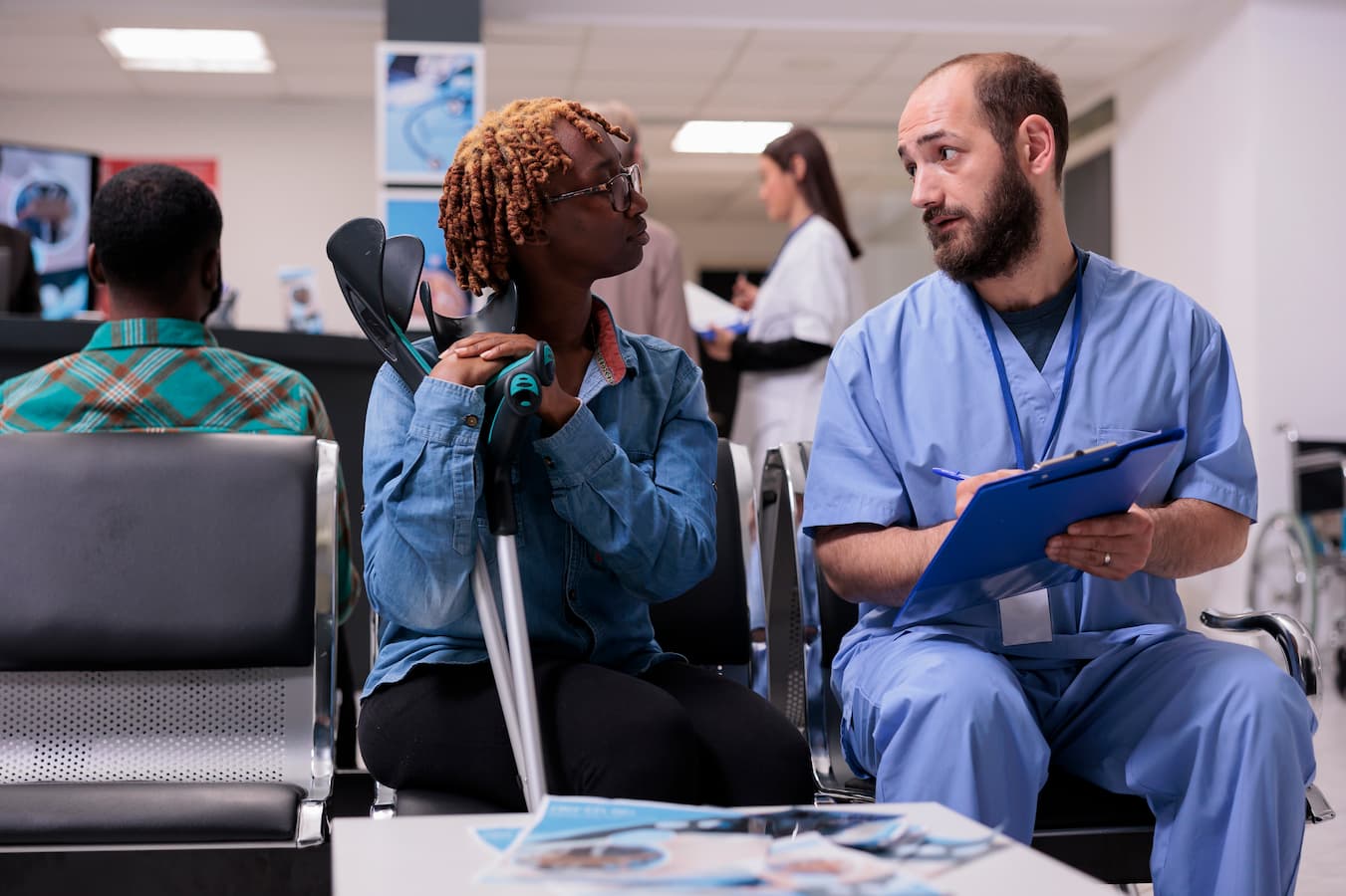Patient speaking with medical staff in clinic waiting area for blood testing in Jacksonville