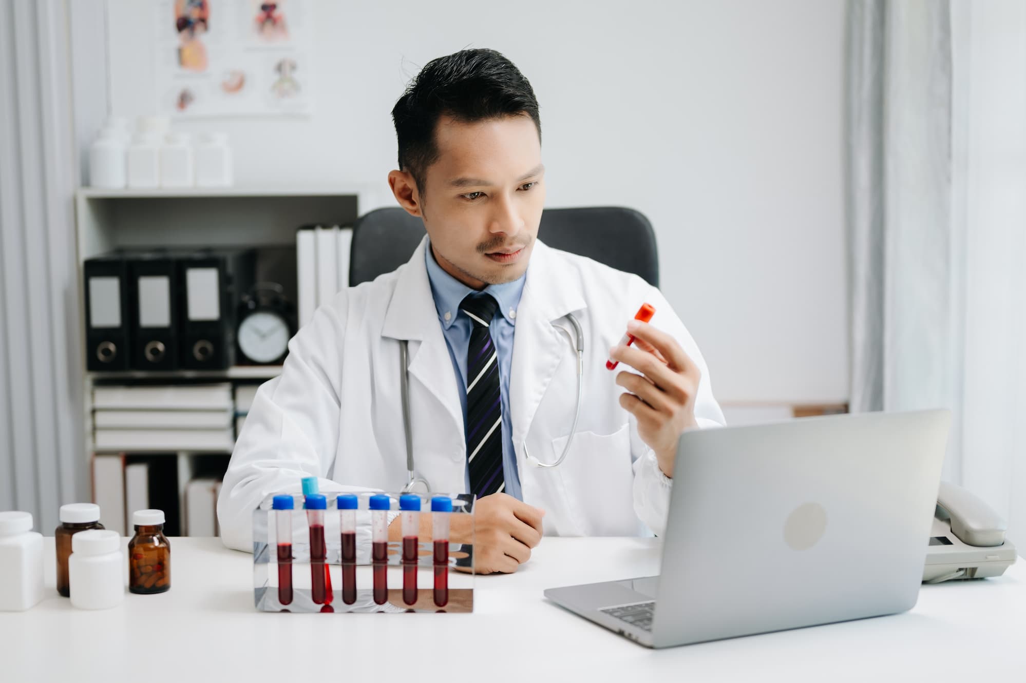Doctor reviewing blood samples while handling online blood test orders in Jacksonville