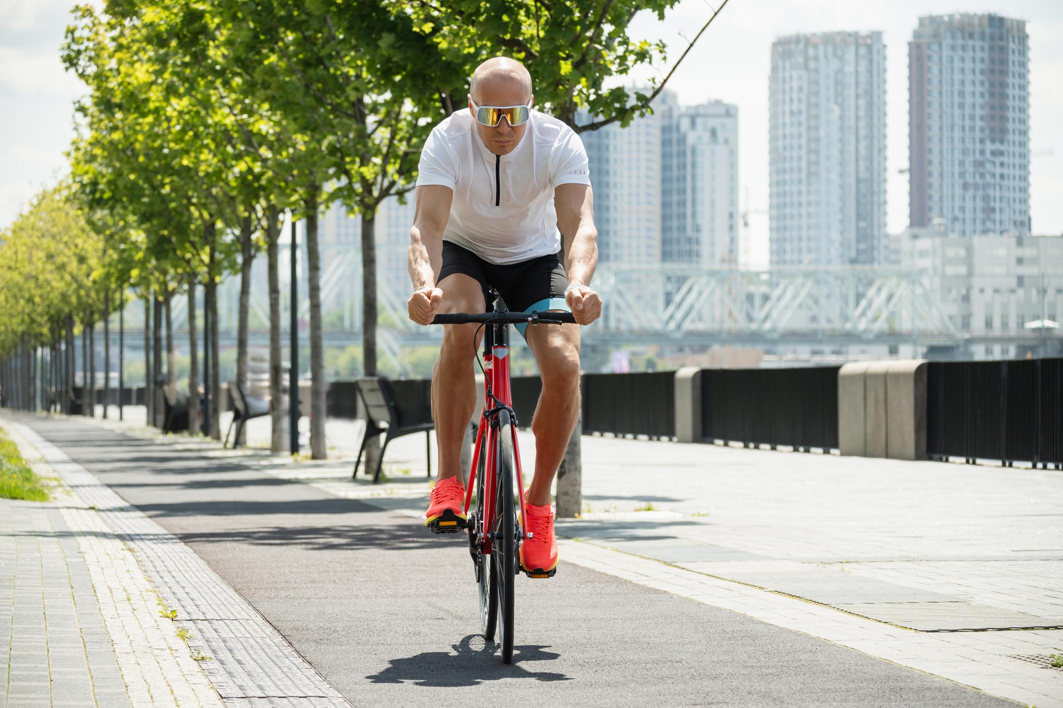 Man riding a bicycle, an activity that may temporarily elevate PSA levels before blood testing.