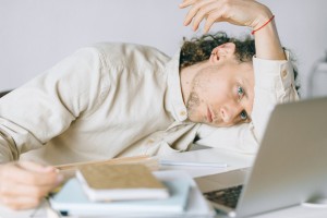 Person experiencing fatigue and low energy, common symptoms of low iron and low Vitamin D
