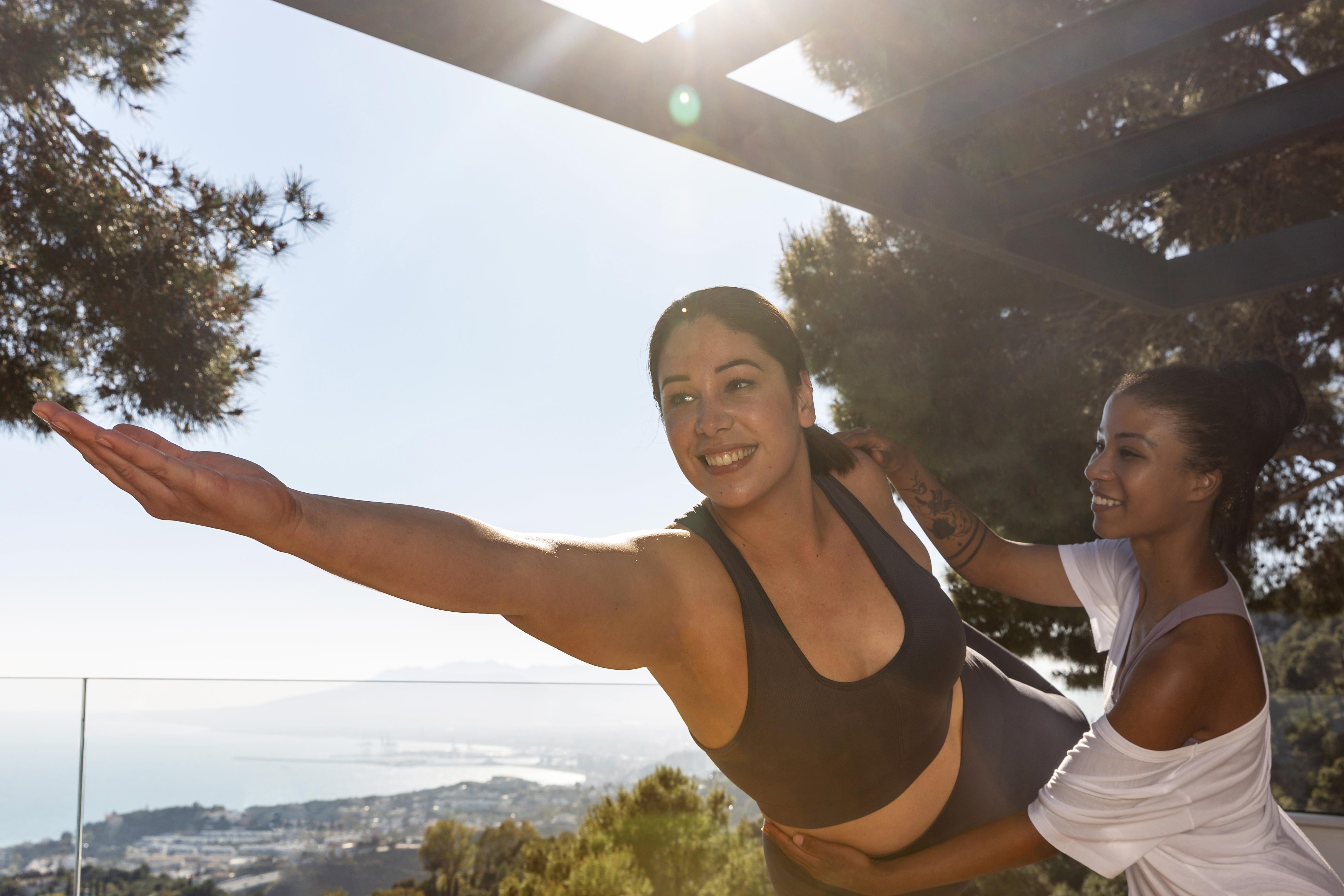 smiley women doing yoga meditation